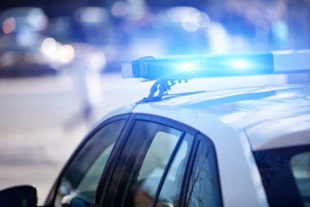 police-car-with-blue-lights-on-the-crime-scene-in-traffic-urban-environment