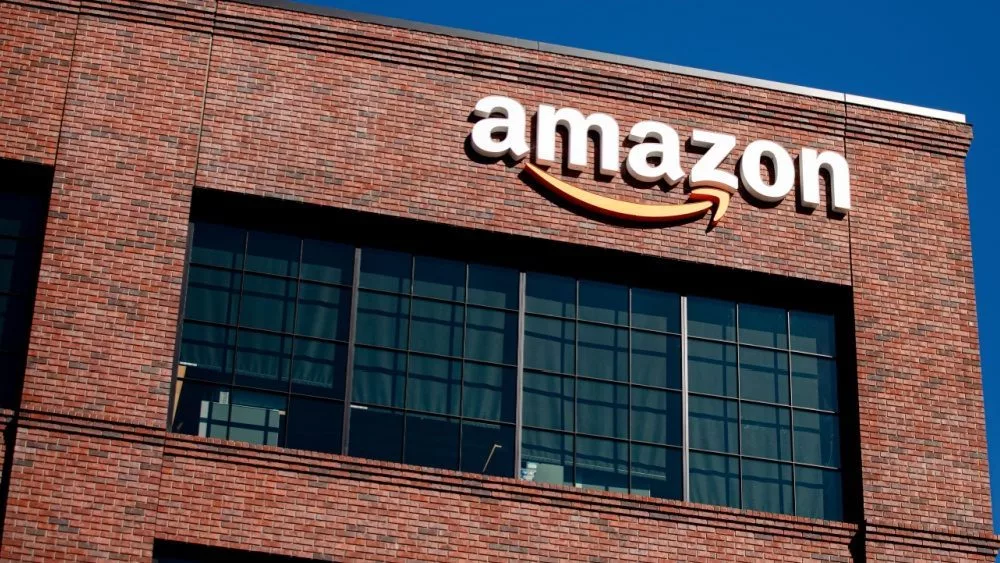 Closeup of Amazon logo on the company office building in East Palo Alto^ Silicon Valley^ San Francisco Bay Area. Amazon sign on brick building wall East Palo Alto^ California US - October 17^ 2024