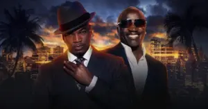 a picture of ne-yo and akon dressed in suits with a sunset skyline behind them