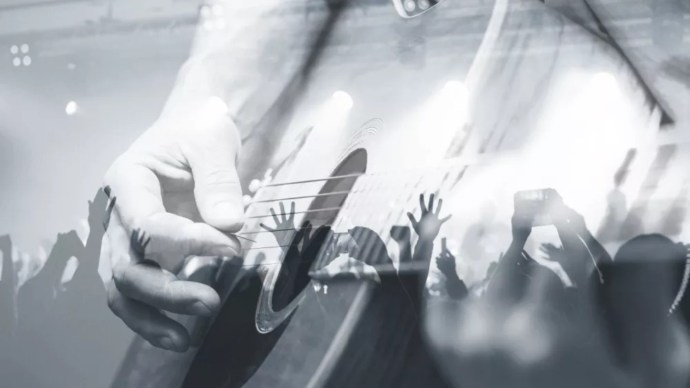 Guitarist with the audience in a double exposure.