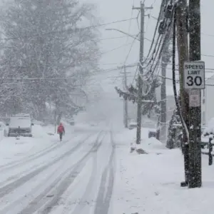 Person is walking in snow storm day on North Taylor Avein Norwalk NORWALK^ CT^ USA -FEBRUARY 7^ 2021