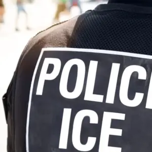 Ice police agent - Officer of Immigration and Customs Enforcement. Close up of POLICE ICE on back of stab proof vest worn by DHS Department of Homeland Security police officer at the scene of incident
