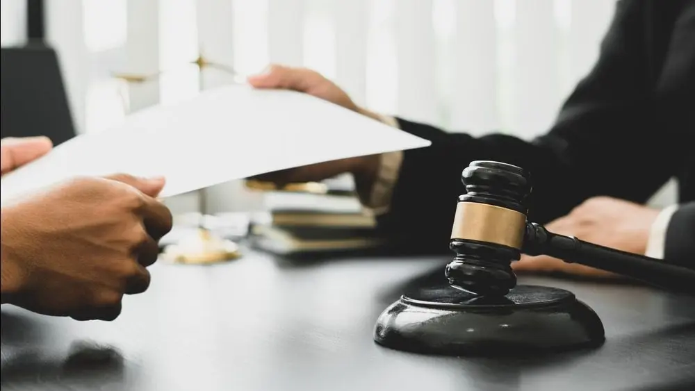 Consulting and finding a solution Concept^ businesspeople consult with a lawyer or judge to find out about business fraud.