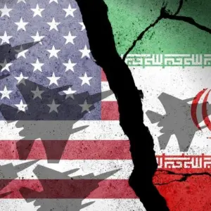 Flag of USA and Iran painted on a concrete wall with airplane shadows