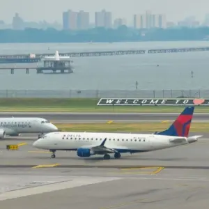 : Delta Airlines and American Eagle planes seen at the runway of LaGuardia International Airport. Manhattan^ New York^ USA - August 5^ 2025