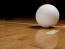 a-white-volleyball-on-a-hardwood-floor