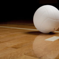 a-white-volleyball-on-a-hardwood-floor