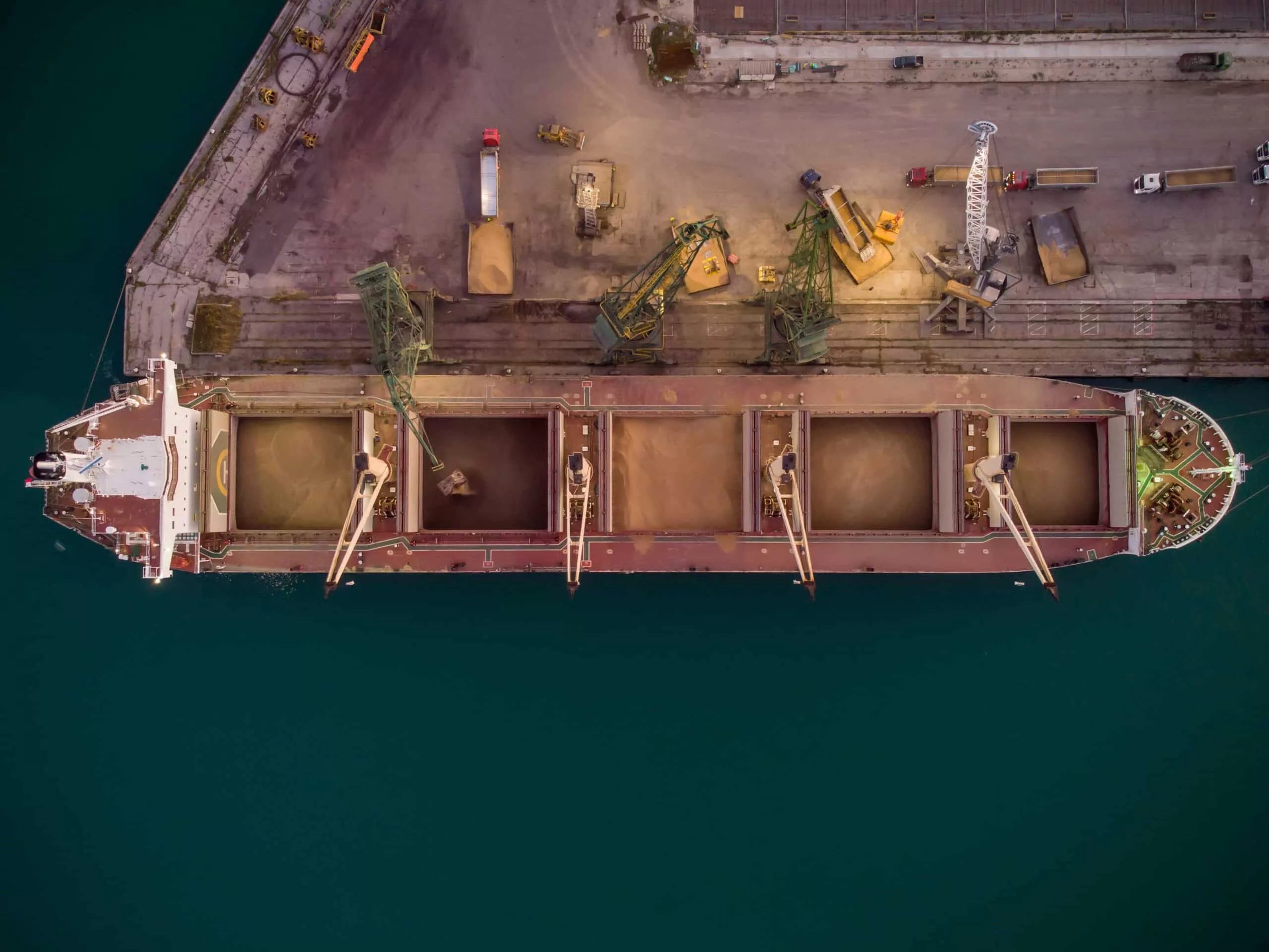 aerial-view-of-big-cargo-ship-bulk-carrier-is-loaded-with-grain-of-wheat-in-port-at-sunset-6