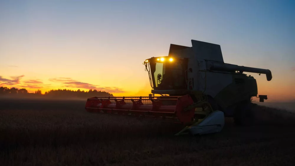 combine-harvester-harvests-ripe-wheat-ripe-ears-of-gold-field-on-the-sunset-cloudy-orange-sky-background-concept-of-a-rich-harvest-agriculture-image-2