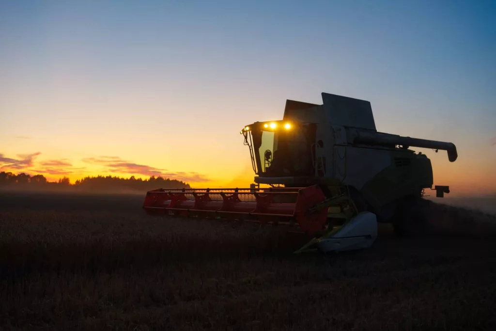 combine-harvester-harvests-ripe-wheat-ripe-ears-of-gold-field-on-the-sunset-cloudy-orange-sky-background-concept-of-a-rich-harvest-agriculture-image-2