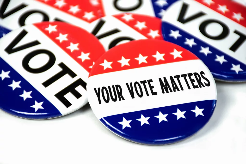 collection-of-election-campaign-vote-pins-on-white