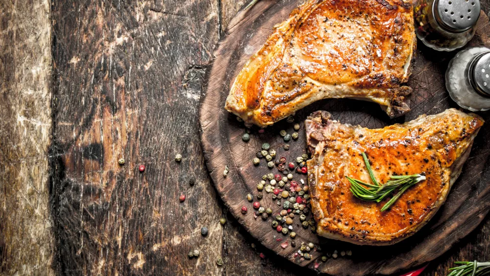 Grilled pork on a cutting Board. On a wooden table.