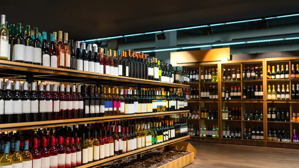 wine-bottles-in-a-row-on-shelves-in-wine-store-alcohol-retail-business