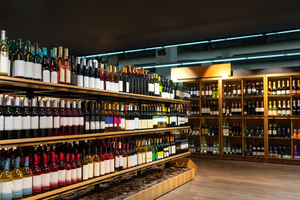 wine-bottles-in-a-row-on-shelves-in-wine-store-alcohol-retail-business