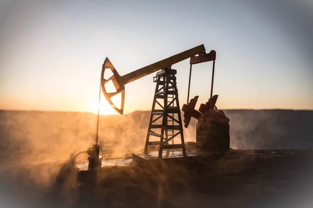 creative-artwork-decoration-oil-pump-and-oil-refining-factory-at-sunset-energy-industrial-concept-selective-focus