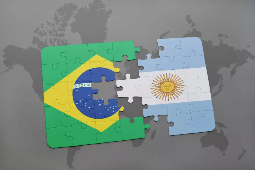 puzzle-with-the-national-flag-of-brazil-and-argentina-on-a-world-map-background
