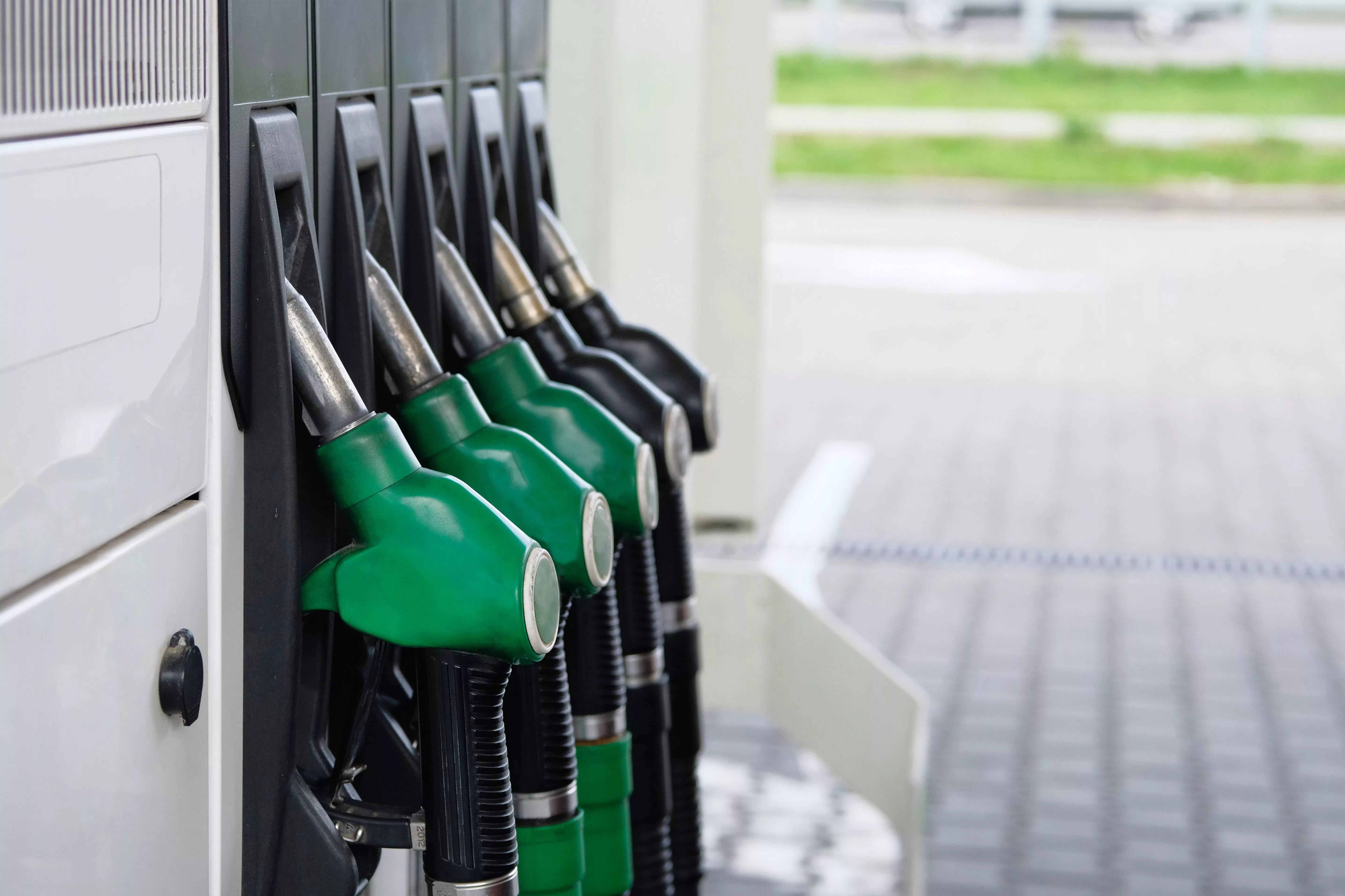 green-and-black-fuel-pistols-on-fuel-station-gas-station-and-petroling-concept-pumping-gas-at-gas-pump
