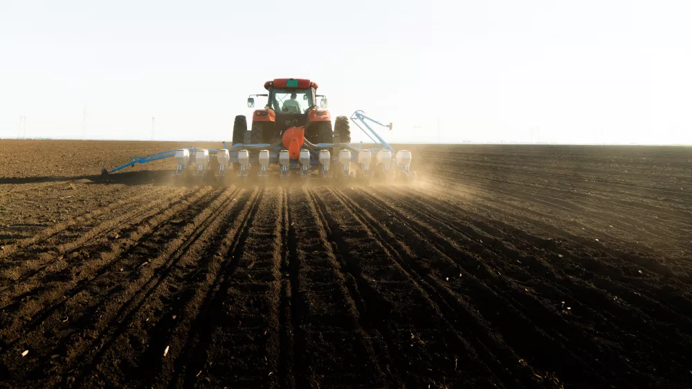 farmer-with-tractor-seeding-soy-crops-at-agricultural-field