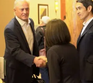 jim-pellman-greeting-japanese-official-at-usw-board-meeting-2024
