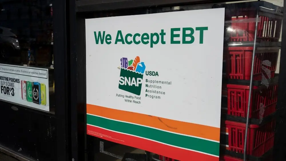 Oregon City, OR, USA - Mar 10, 2022: "We Accept EBT" sign is seen at the entrance to a 7-Eleven store in Oregon City. The Supplemental Nutrition Assistance Program (SNAP) is a federal program.