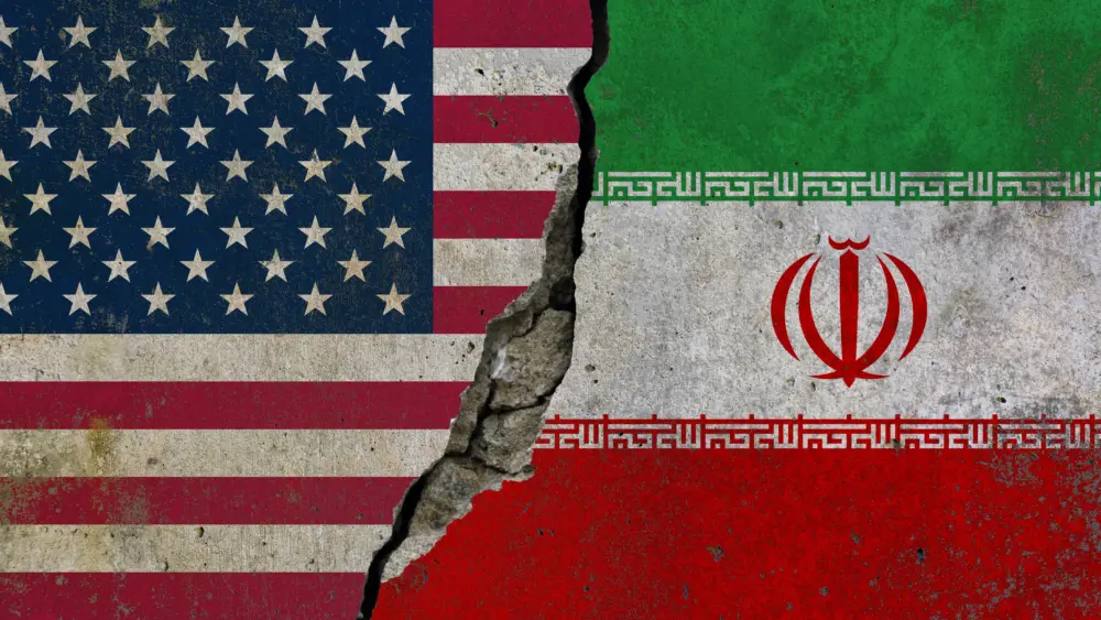 united-states-and-iran-political-conflict-concept-with-cracked-flags-background