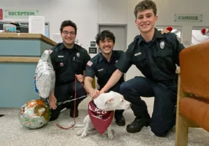 From left, Moscow Firefighters Luca Atencio, Ronan Hall, and Aiden Koval pose for a photo with Yuna, a dog they rescued from a Feb. 16, 2025 house fire in Moscow on Sunday, Feb. 23, 2025, at the Veterinary Teaching Hospital in Washington State University's College of Veterinary Medicine in Pullman. Yuna was treated at the VTH for several days using a ventilator and oxygen. (College of Veterinary Medicine/Josh Babcock)