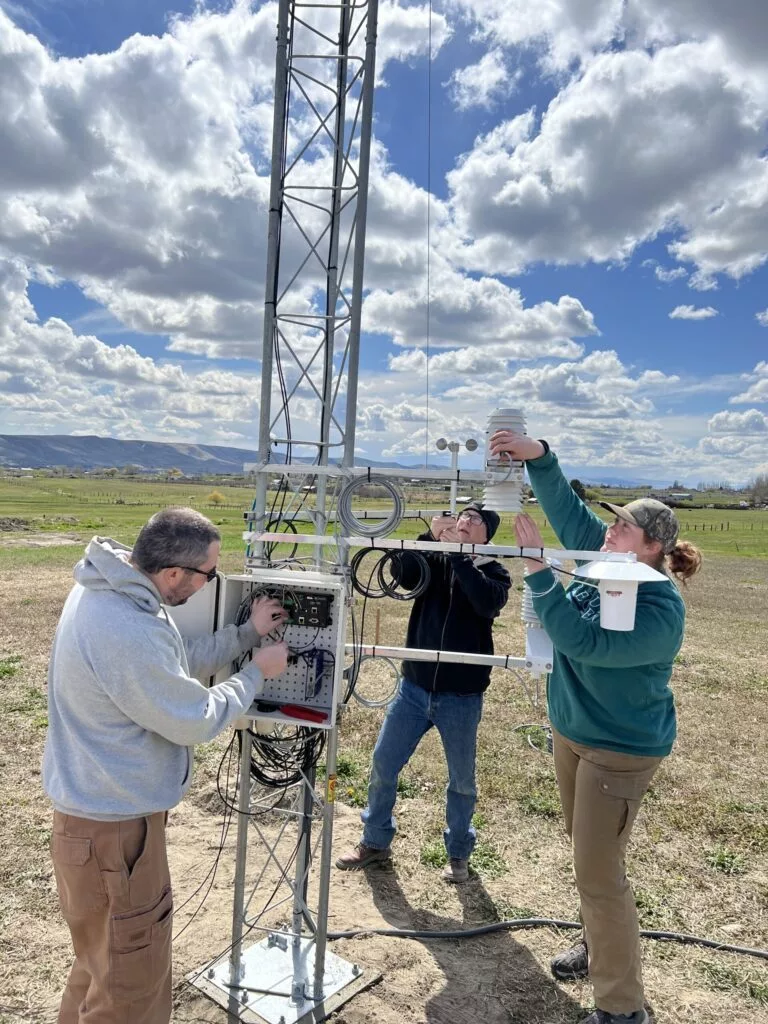 AgWeatherNet field team members Jon Contezac, Derek Weaver, and Bethany Safe upgrade the network’s Prosser meteorological station in 2023. A new project funded by the Washington State Department of Agriculture will add new, next-generation stations while helping educate high school students in Washington.AgWeatherNet field team members Jon Contezac, Derek Weaver, and Bethany Safe upgrade the network’s Prosser meteorological station in 2023. A new project funded by the Washington State Department of Agriculture will add new, next-generation stations while helping educate high school students in Washington.