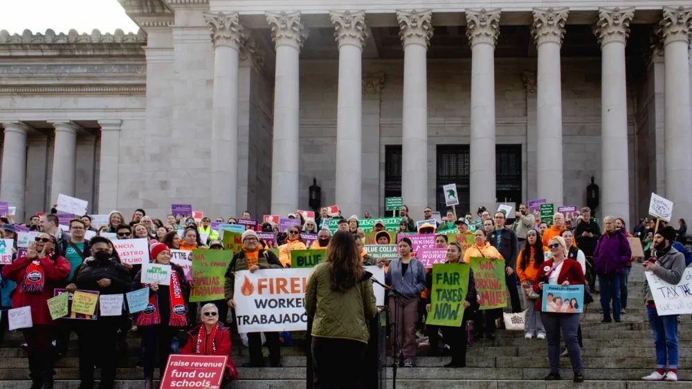 Hundreds of people gathered at the Washington state Capitol on Monday to urge the Legislature to adopt progressive tax policies and not cut funds for public services and education in response to a projected budget deficit. (Photo by Jacquelyn Jimenez Romero/Washington State Standard)