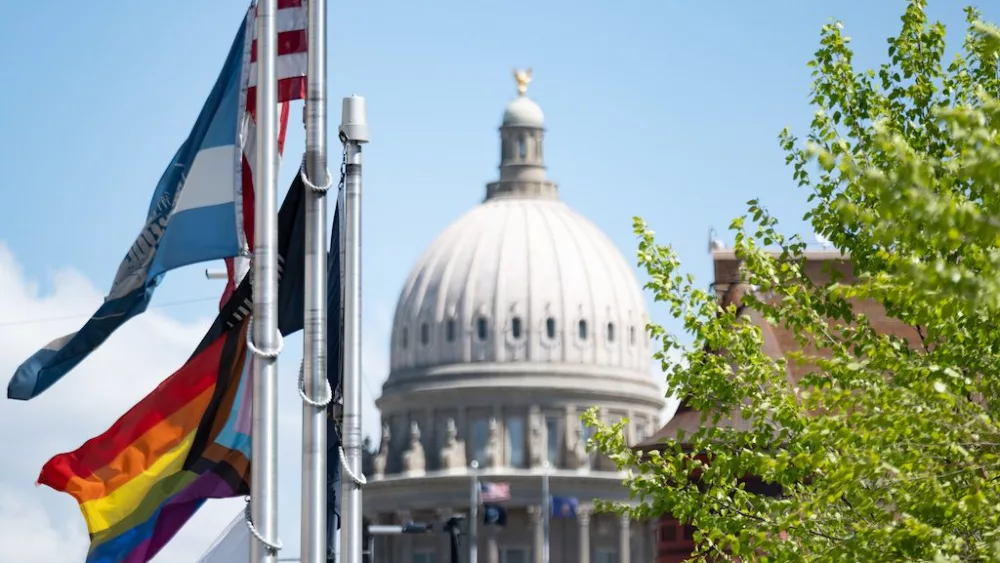 A Pride flag flies in front of Boise City Hall, just blocks from the Idaho Capitol. The flag flies below the city’s own banner and in April shared the flagpole with a flag honoring organ donation. The city also displays the U.S. flag, a POW/MIA flag and a state of Idaho flag. (Erika Bolstad/Stateline)