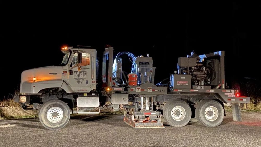 A 53,000-pound vibroseis truck, with a hydraulic vibration plate that creates signals like tiny earthquakes. The truck is parked at a roadside pullout near the Continental Divide in Yellowstone National Park. (Photo by Jamie Farrell, University of Utah, September 2020, taken under Yellowstone National Park research permit YELL-2020-SCI-8146. Support for the field research was provided by the National Science Foundation)