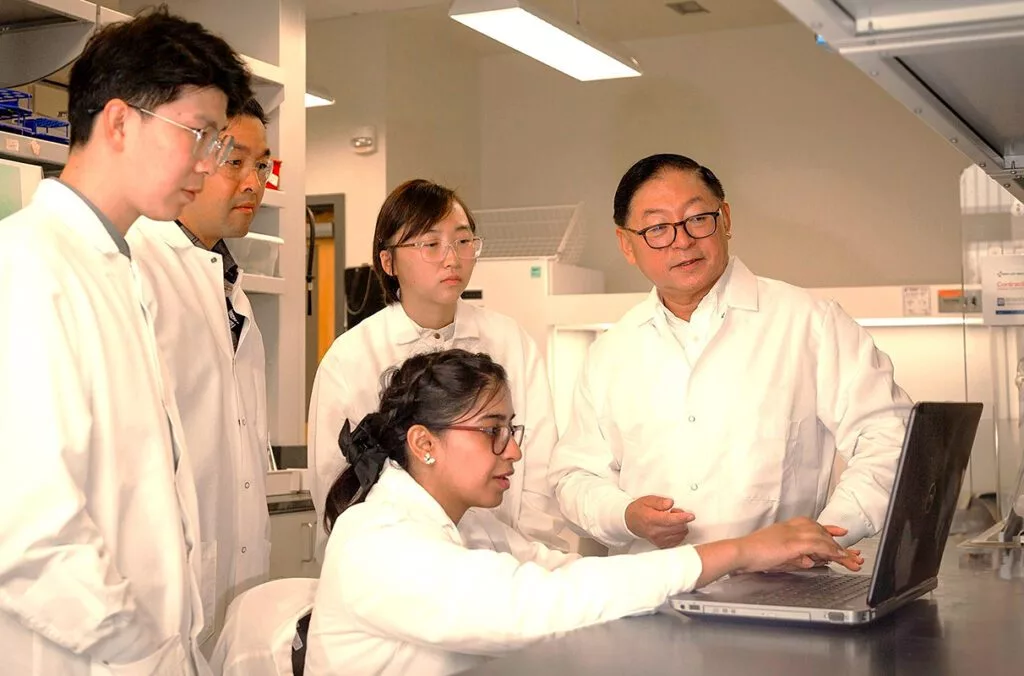 Developing new and sustainable fuels and products from biomass, Professor Bin Yang works with members of his lab at WSU Tri-Cities. Yang led research into new, economically feasible production of sugar for biofuels.