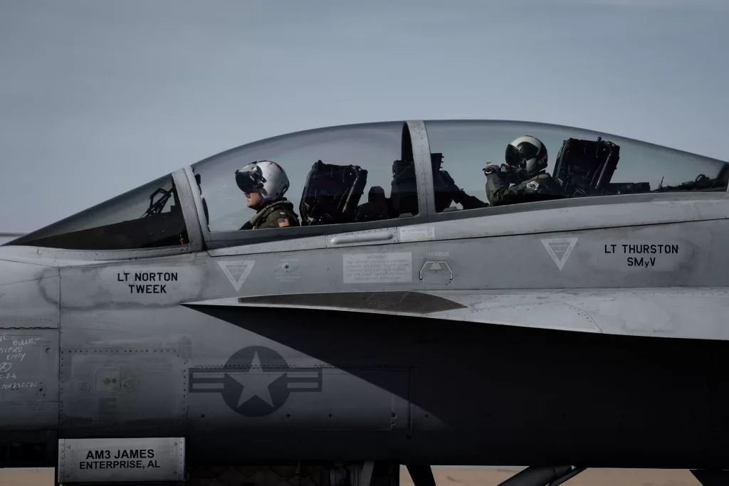 U.S. Air Force Gen. CQ Brown, Jr., Chairman of the Joint Chiefs of Staff, rear, and U.S. Navy Captain Chad Heirigs, Deputy Commander of Carrier Air Wing (CVW) 11, prepare to exit an F/A-18F Super Hornet after landing on Naval Air Staion North Island, Dec. 3, 2023. Brown and Heirigs flew from the Nimitz-class aircraft carrier USS Theodore Roosevelt. (DOD Photo by Chief Mass Communication Specialist James Mullen)