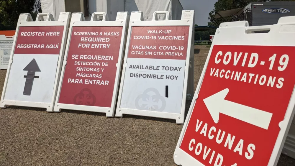In this file photo, signs lead people to a COVID-19 vaccination clinic set up at a park in Caldwell.