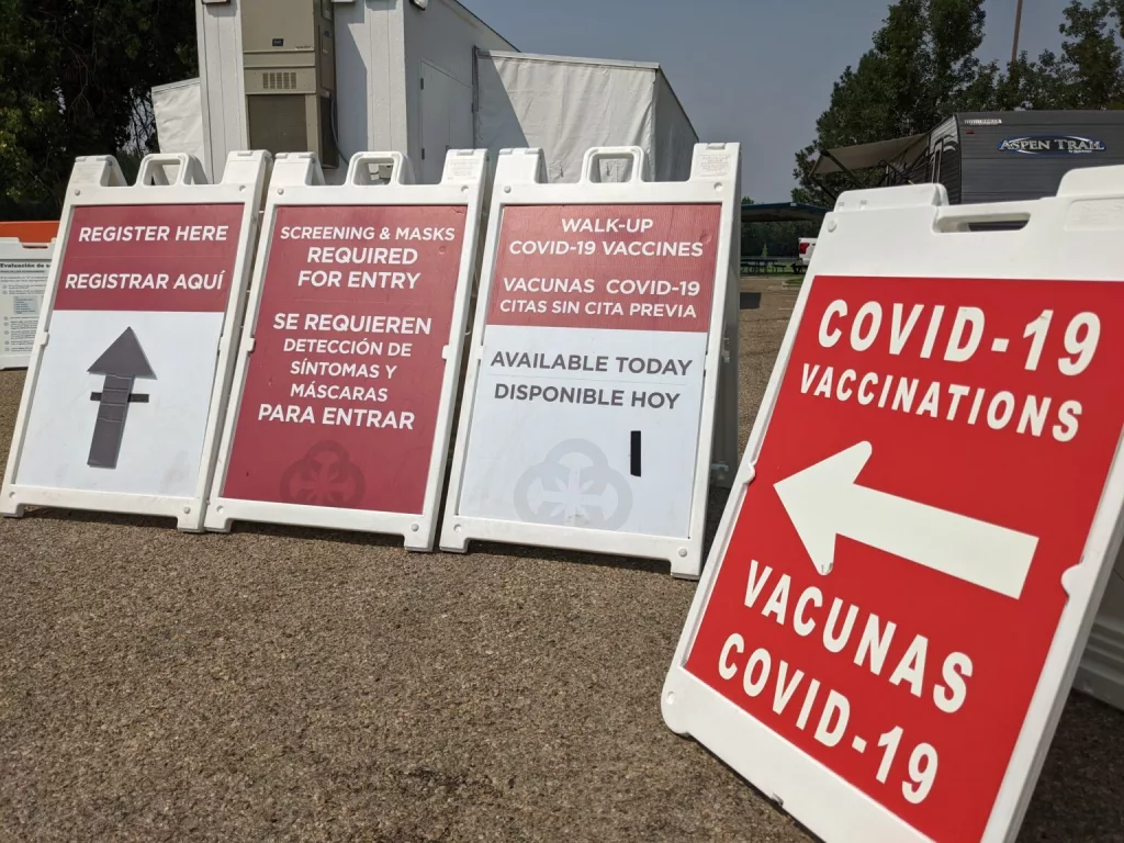 In this file photo, signs lead people to a COVID-19 vaccination clinic set up at a park in Caldwell.