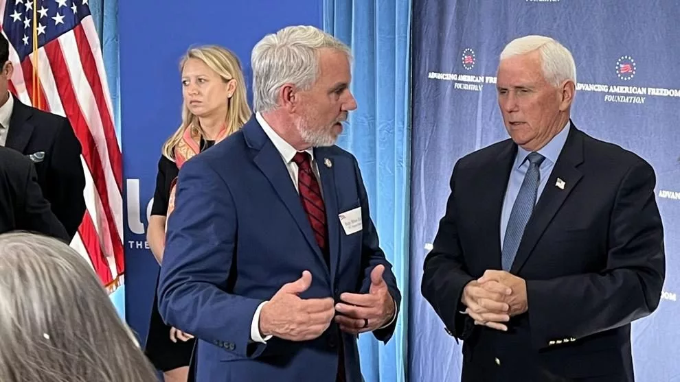 Rep. Blair Eddins, R-Wilkes, and former Vice President Mike Pence discuss the impact of tariffs following a roundtable discussion in Raleigh, N.C., on Monday, May 19, 2025. With Pence on the dias were Tim Chapman, president of Advancing American Freedom; Chris Chung, Economic Development Partnership of North Carolina; Rodney Pitts, of the John Locke Foundation and owner of Southern Elevator; Bob Luddy, founder and president of CaptiveAire; Art Pope of Variety Wholesalers and chairman of John William Pope Foundation; Donald Bryson, CEO of the John Locke Foundation; and H.O Woltz, president of Insteel Industries. Alan Wooten | The Center Square