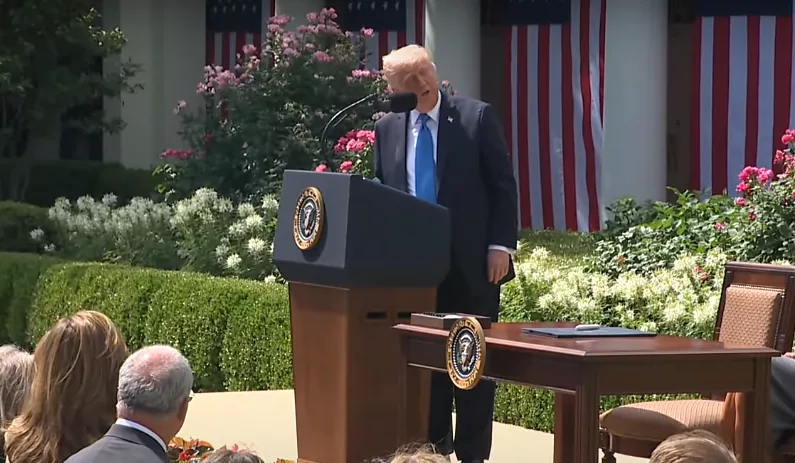 President Donald Trump addresses a group gathered for the signing of the Take It Down Act, a bill aiming to curb online sexual exploitation and which First Lady Melania Trump championed to Congress.