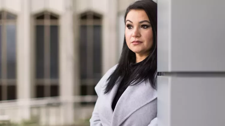 Gina Bloom, a 39-year-old mother of two, stands outside the Snohomish County Superior Courthouse in Everett, Wash. In 2021, Bloom lost custody of her sons — just as the court-appointed guardian ad litem suggested. Dan DeLong/InvestigateWest