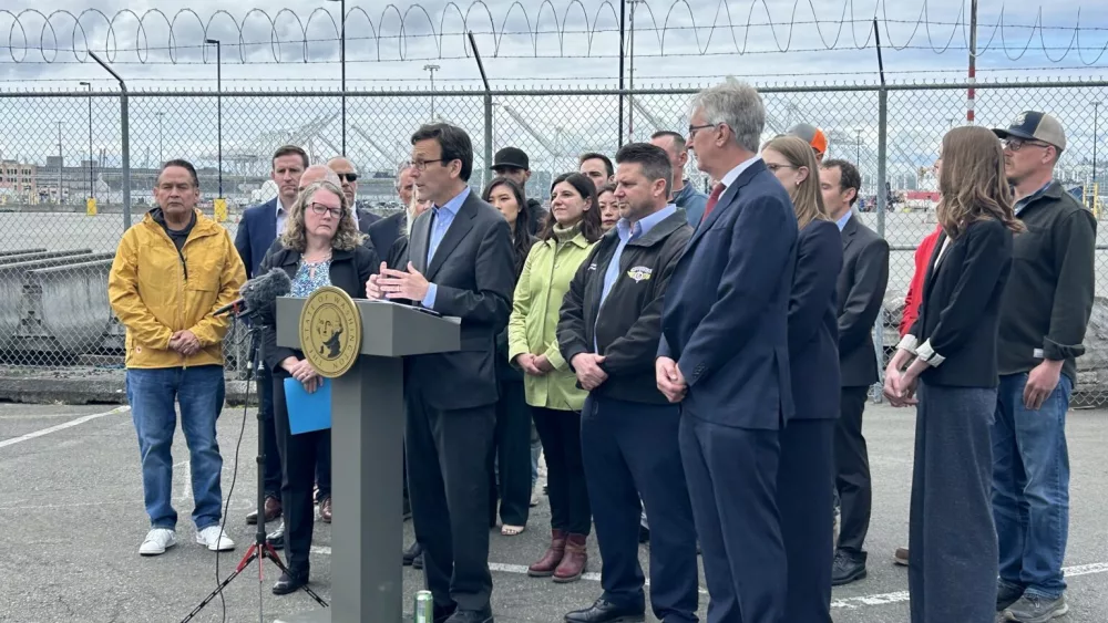 Gov. Bob Ferguson slams President Donald Trump’s tariffs in a press conference alongside union leaders, lawyers, elected officials and others at the Port of Seattle on Wednesday, May 21, 2025. (Photo by Jake Goldstein-Street/Washington State Standard)