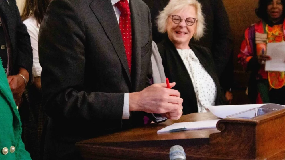 Gov. Bob Ferguson using a red pen to partially veto a bill on Tuesday, May 20, 2025. (Photo by Jacquelyn Jimenez Romero/Washington State Standard)
