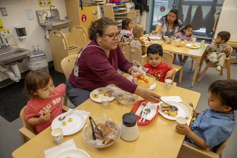 Maria Saulness has lunch with children at the Sue Krienan Early Learning Center, Skagit/Island Early Head Start Program associated with Skagit Valley College.(Ting-Li Wang for Cascade PBS)