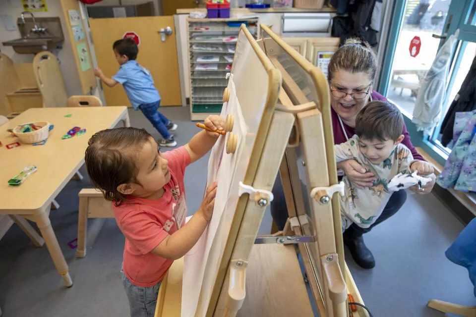 Washington’s Head Start Association is suing the Trump administration over funding cuts that have led to confusion, some temporary closures and layoffs of administrative staff. Meanwhile, the state is cutting funds to state early learning programs. Providers in the programs, such as the Skagit/Island Head Start at Skagit Valley College, which serves the most-vulnerable families in Washington, are caught in the middle and anxious about what’s next. Isabella Jimenez, 3, left, and teacher Maria Saulness with Duane Kusler, during playtime at the Sue Krienan Early Learning Center, Skagit/Island Early Head Start Program, May 21, 2025. (Ting-Li Wang for Cascade PBS)