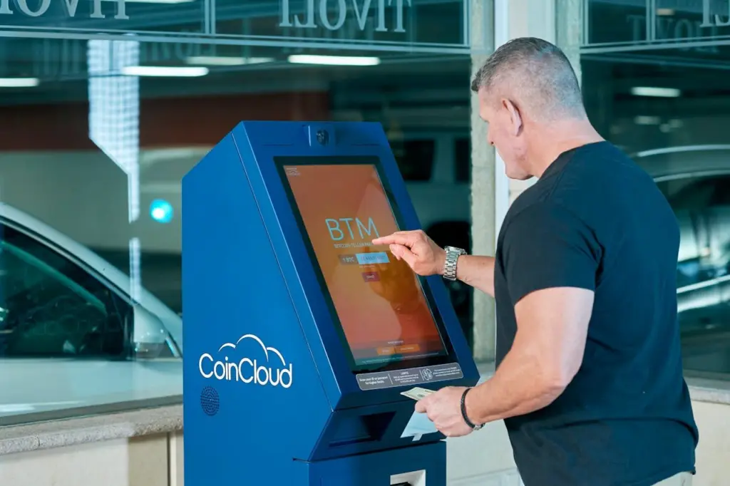 Photo by Elise: https://www.pexels.com/photo/a-man-in-black-shirt-using-atm-6132773/