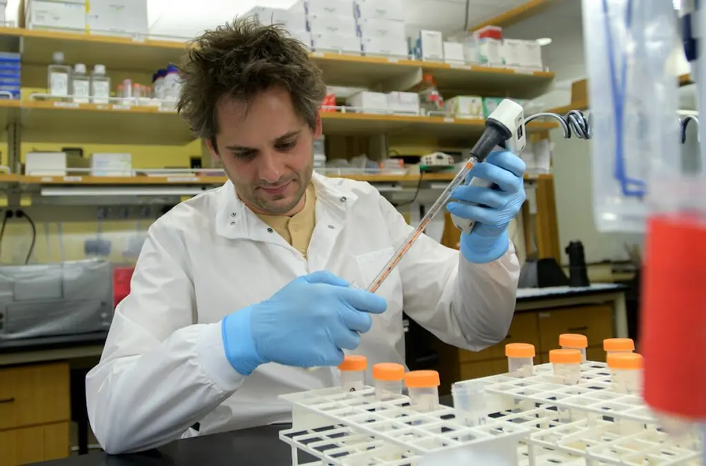 Michael Letko, a molecular virologist and assistant professor in WSU’s College of Veterinary Medicine, works in his lab in 2023. (Photo by Ted S. Warren/College of Veterinary Medicine)