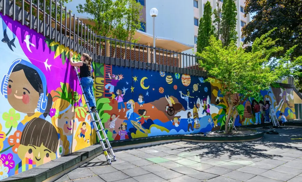 WSU students in Art 362 add details to a mural they are painting at the WSU Children’s Center, Tuesday, June 3, 2025, in Pullman, Wash.