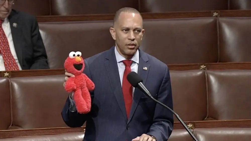 U.S. House Minority Leader Hakeem Jeffries, D-N.Y., holds up an Elmo toy while the chamber debates a bill that would eliminate previously approved funding for the Corporation for Public Broadcasting, which provides grants to public radio and television stations, including the Public Broadcasting Service, or PBS, which airs “Sesame Street.” (Screen shot taken from House Clerk website livestream.)