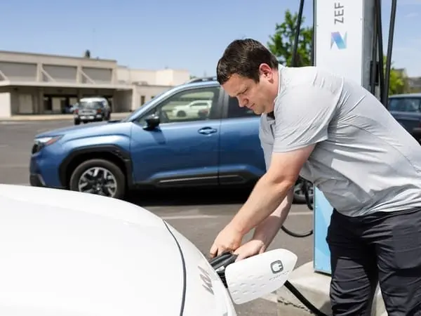 Brian Hedengren charges his 2022 Kia Niro in Yakima on Wednesday, June 11, 2025. “ I was already interested in an EV,” Hedengren said. The rebate “sealed the deal.” He was not required to submit proof of his self-reported income when applying for the state EV rebate. (Emree Weaver for Cascade PBS)