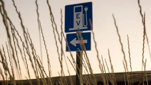 A sign just off Highway 195 points the way to the electric vehicle charging station that was recently installed at the historic gas station in Rosalia, Washington. (Rajah Bose for Cascade PBS)
