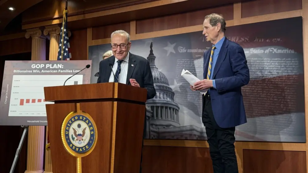 U.S. Senate Minority Leader Chuck Schumer, D-N.Y., speaks during a press conference inside the Capitol building on Wednesday, June 18, 2025. Oregon Democratic Sen. Ron Wyden is at right. (Photo by Jennifer Shutt/States Newsroom)