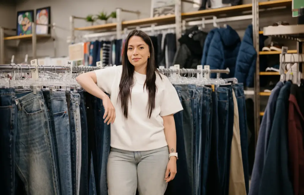 Shirley Mendez, an alum of the Treehouse program, poses for a portrait in the Treehouse Store in Seattle, where she got school supplies, books and clothing that made an impact on her health and success, on Wednesday, June 11, 2025. (Grant Hindsley for Cascade PBS)