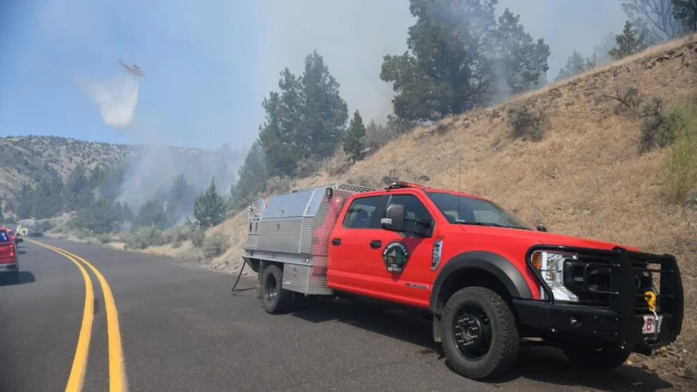 A helicopter drops flame retardant on the Cram Fire burning in Jefferson and Wasco counties on July 15, 2025. (InciWeb/U.S. Forest Service)